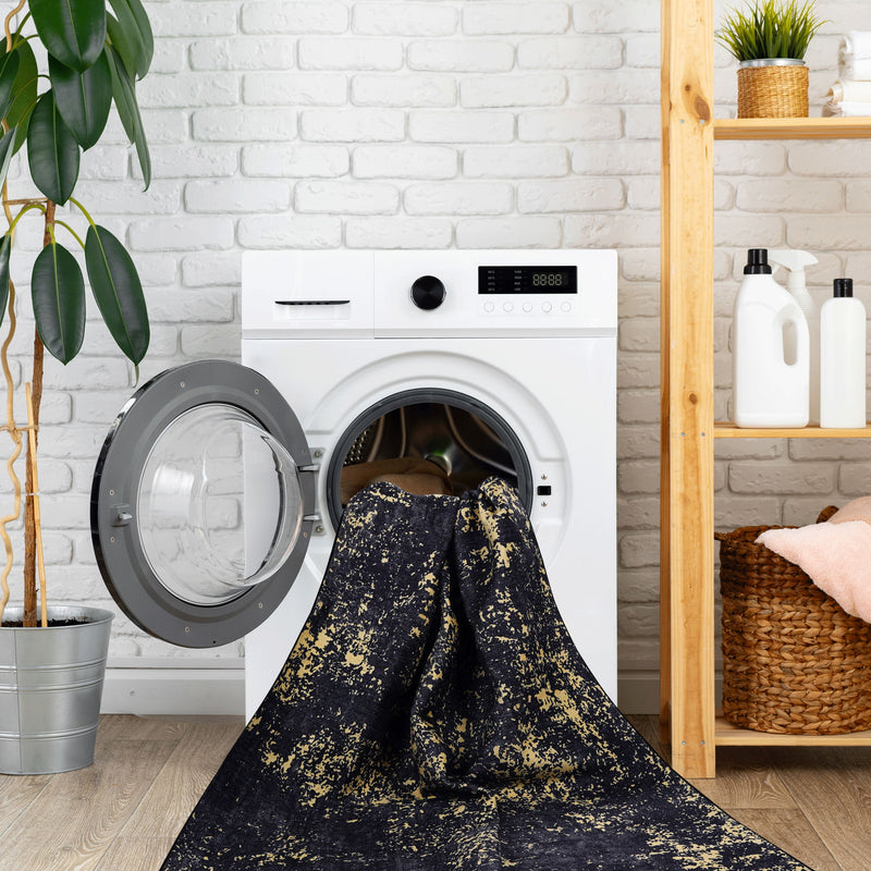 Maval - 6' X 9' Washable Area Rug - Black / Gold